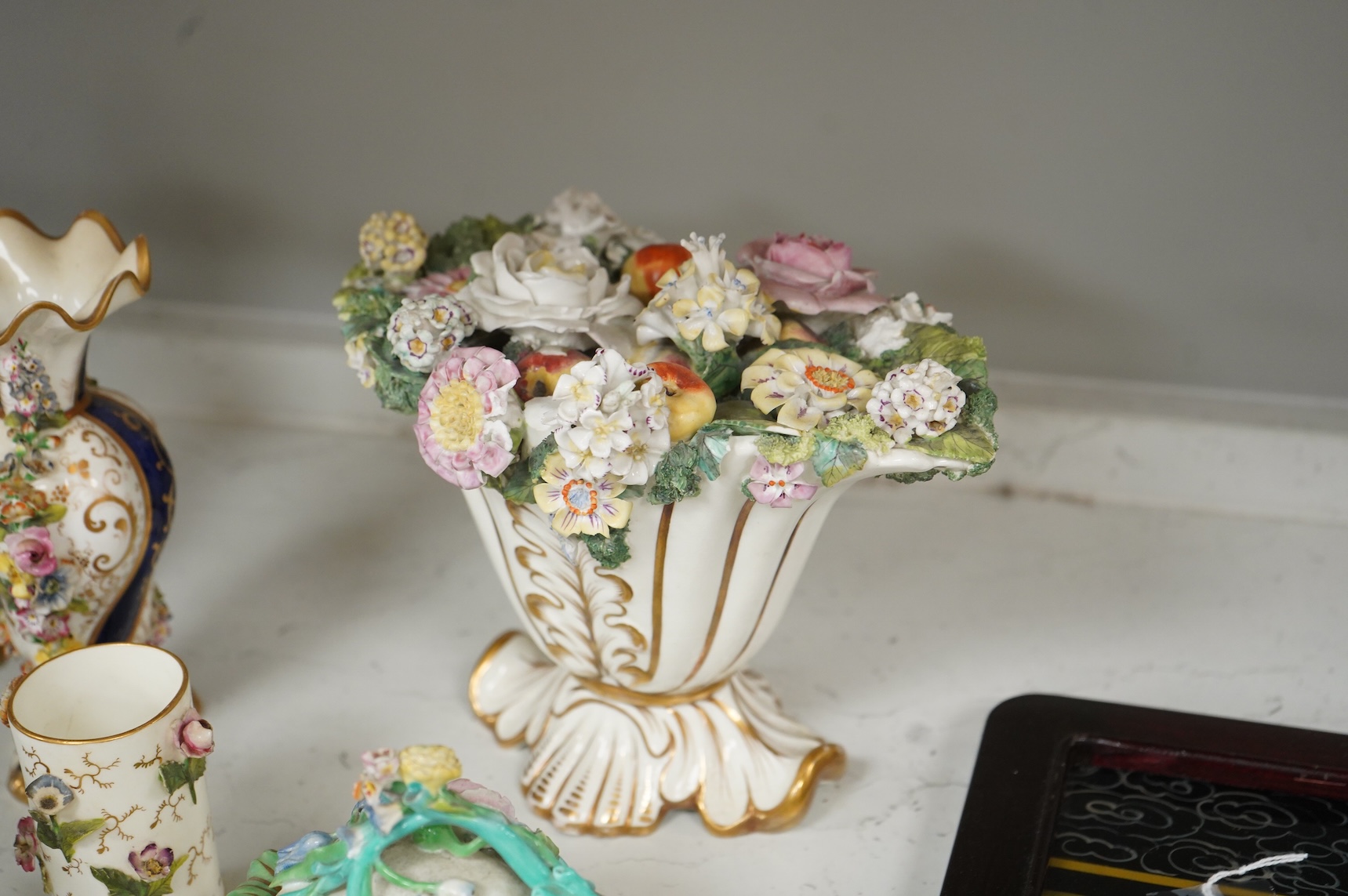 Large group of 19th/20th century English ceramics, to include a Rockingham basket, other English porcelain flower encrusted vessels, a Copeland and Garrett ewer, a Minton Sevres style beaker, a Wedgwood agate ware jug, R